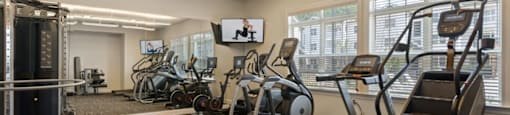 Ashland Farms Fitness Center with Large Windows, TV, and Various Cardio Equipment