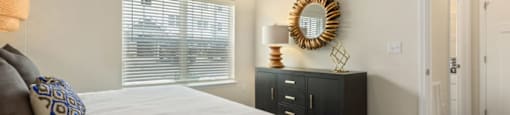 Apartments In Ashland City - Ashland Farms - Bedroom With Plush Carpeting, Bed, Large Window, and Ceiling Fan