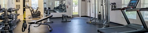 a gym with weights and other exercise equipment at the monarch apartments