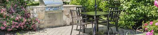 Outdoor grilling station with tables and grill
