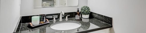 a white bathroom with a sink and a mirror