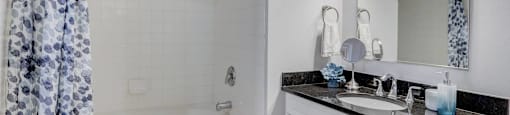 Bathroom with faux hardwood floors, white trim, neutral walls, and soaking tub.