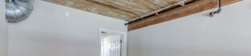 an empty room with a wooden floor and white walls