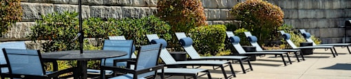 an outdoor patio with tables and chairs and an umbrella