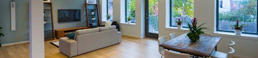 A living room with a couch, chairs, and a table.
