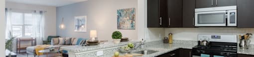 A modern kitchen with dark wood cabinets and a white island.