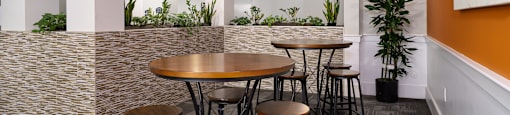 A modern dining area with a round table and chairs.