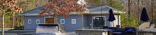 A house with a stone pillar in front of it.