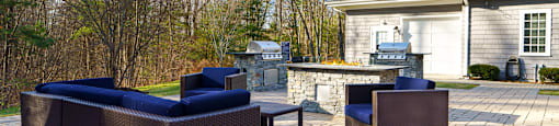 A patio with a couch and a chair.