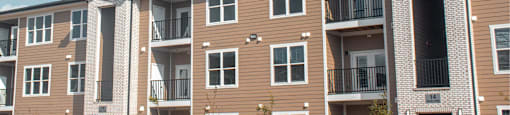 Apartment building with balconies and a clear sky.