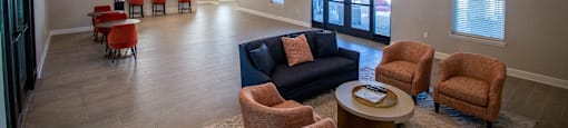 A spacious living room with a high ceiling and a large window.