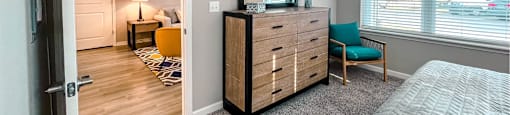 A bedroom with a bed, dresser, and mirror.