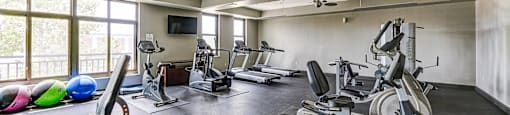A spacious home gym with a variety of exercise equipment.