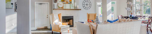 A living room with a fireplace and a large couch.