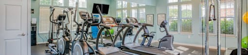 A spacious home gym with a variety of exercise equipment.