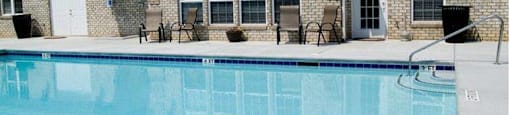 A pool in front of a house with a sign that says 3 ft no diving.