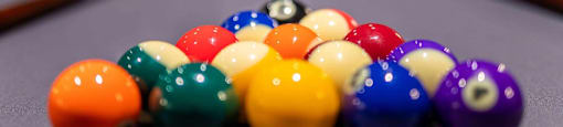 A pool table with a variety of colored balls.