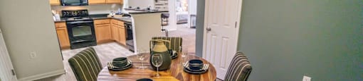 A dining room with a table set for four.