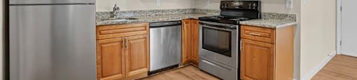 A kitchen with wooden cabinets and stainless steel appliances.