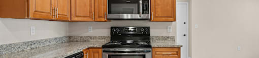 A kitchen with wooden cabinets and stainless steel appliances.