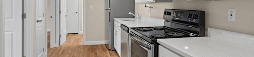 A kitchen with white cabinets and stainless steel appliances.