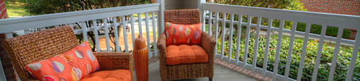 A patio with two chairs and a table.
