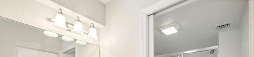 A bathroom with a white sink and a mirror above it.