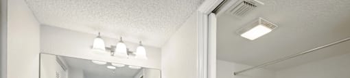 A white bathroom with a white tub and a white sink.