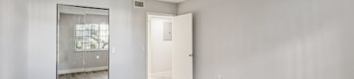 A room with a wooden floor and white walls.