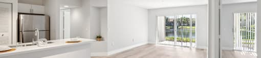 A spacious kitchen with white cabinets and a wooden floor.