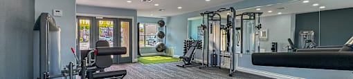 A well-equipped gym with a variety of machines and weightlifting equipment.
