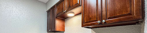 A kitchen with wooden cabinets and a granite countertop.