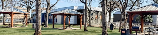 A park with a gazebo and picnic tables.