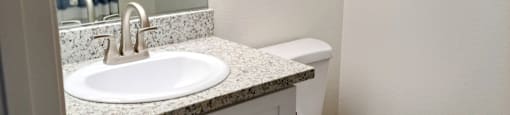 A white toilet sits next to a sink in a bathroom.