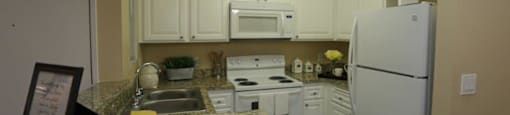 Kitchen With White Cabinetry And Appliances at Citrus Gardens Apartments, Fontana, 92335