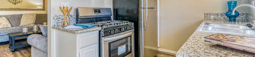 A kitchen with a stainless steel refrigerator and oven.