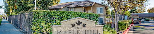 an image of the maple hill apartments sign in front of the building