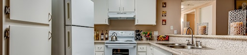 a kitchen with white cabinets and white appliances