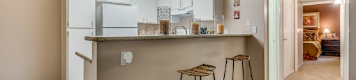 a kitchen with a breakfast bar and stools