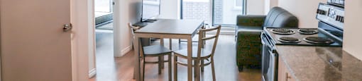 A kitchen with a table and chairs in the middle of the room.