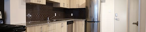 A kitchen with wooden cabinets and a black stove top.