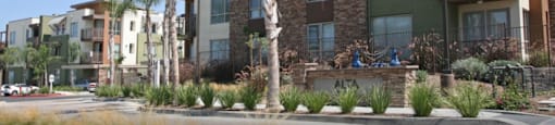 an image of an apartment building with palm trees in front of it