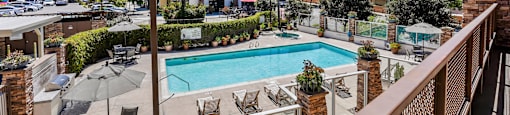a view of the pool from a balcony at the resort