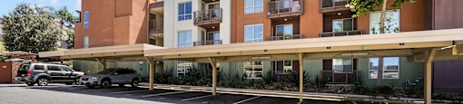 an empty parking lot in front of an apartment building