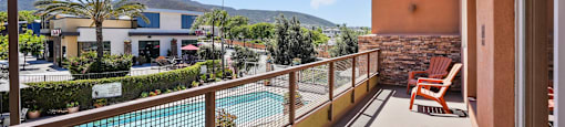 a balcony or terrace with a view of a swimming pool