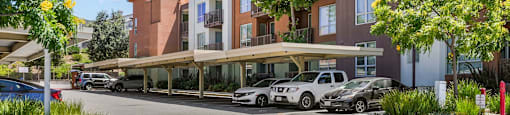 a rendering of a parking lot in front of an apartment building