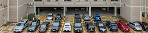 an apartment building with a parking lot full of cars