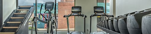 a gym filled with cardio equipment and treadmills