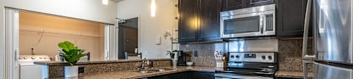 a kitchen with stainless steel appliances and granite counter tops