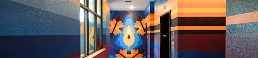 a hallway with a colorful mural on the wall